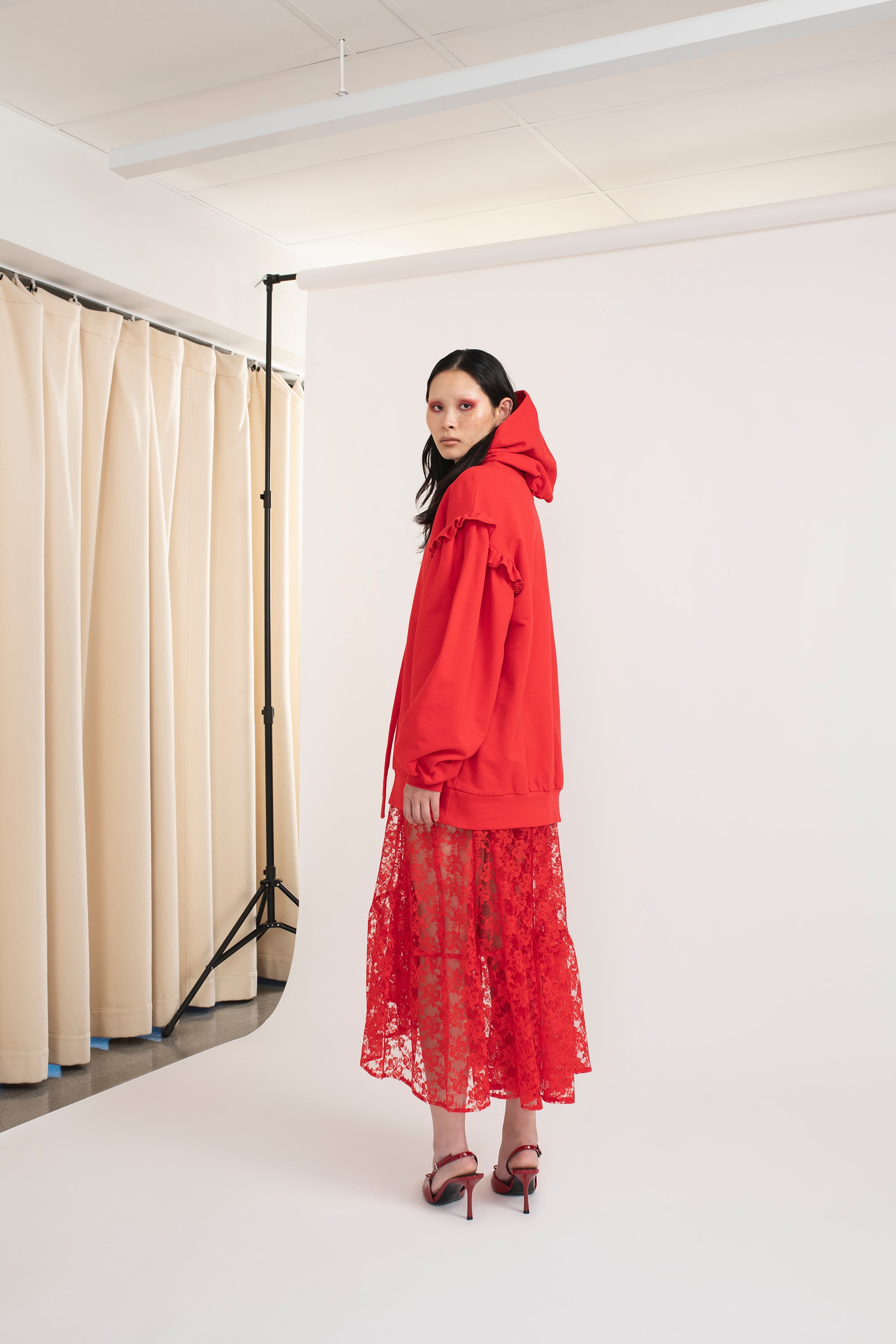 Mirkka Metsola Ruffle Hoodie in Red from the side.